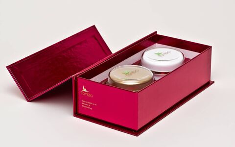 Ein Körperpflege Geschenkset mit zwe Tiegel Creme im roten Geschenkkarton